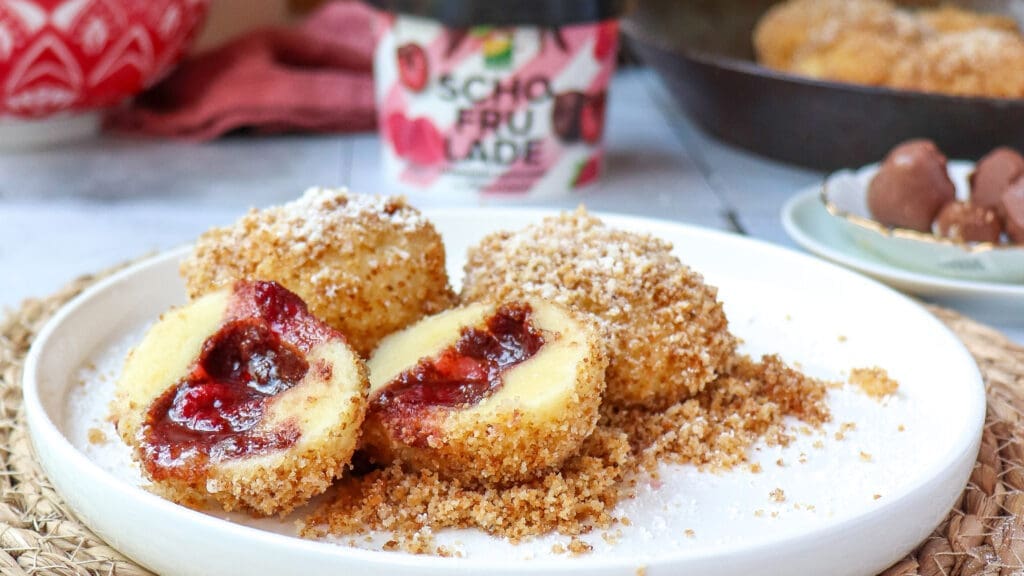 Zwei aufgeschnittene Schofrulade Knödel auf einem weißen Teller