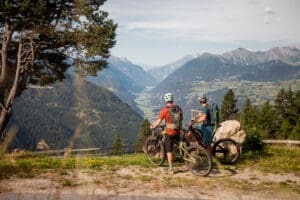 Zwei Mountainbiker genießen die Aussicht mit einem tollen Blick ins Tal