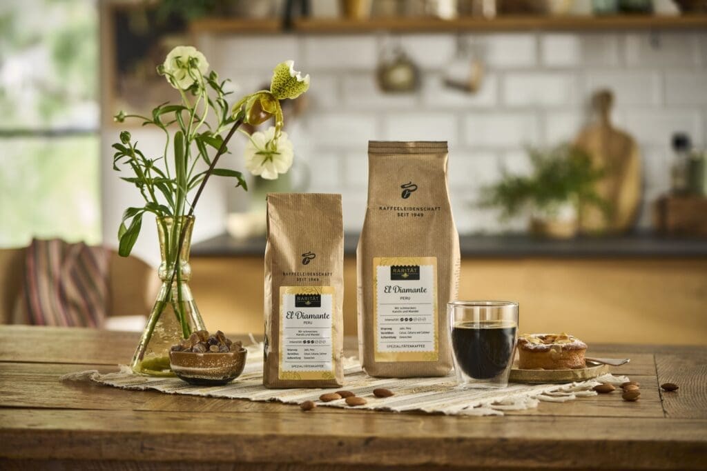 Kaffee in Sackerl auf Esstisch mit Blumen